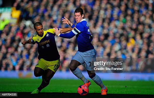 Everton player Ross Barkley challenges Wayne Routledge of Swansea during the FA Cup Fifth Round match between Everton and Swansea City at Goodison...