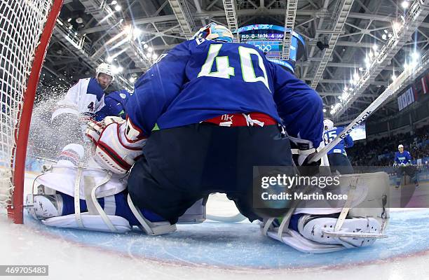 David Backes of the United States shoots and scores against Luka Gracnar of Slovenia in the third period during the Men's Ice Hockey Preliminary...