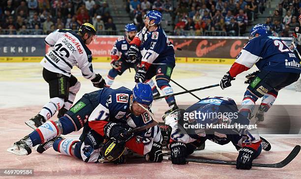 Christoph Gawlik of Ingolstadt is challenged by Marcus King of Mannheim and Andrew Joudrey of Mannheim during the DEL Play-offs Final Game 3 between...