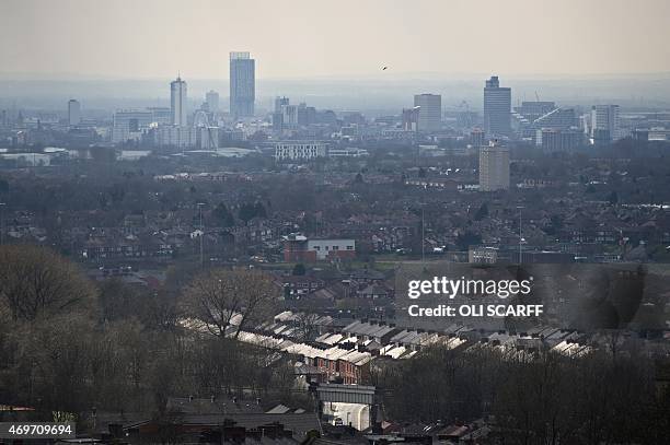 Manchester city skyline is seen from Oldham above the streets of terraced houses in north west England on April 7, 2015. As a general election looms,...