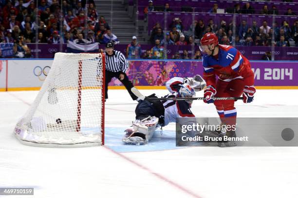 Ilya Kovalchuk of Russia scores a winning goal in a shoot against Jan Laco of Slovakia during the Men's Ice Hockey Preliminary Round Group A game on...