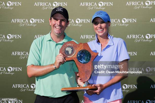 Thomas Aiken of South Africa and his wife and caddie Kate Aiken pose with the trophy after winning the Africa Open at East London Golf Club on...