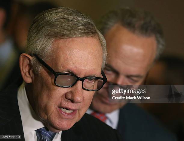 Senate Minority Leader Harry Reid speaks to the media while flanked by Sen. Chuck Schumer during a news conference at the U.S. Capitol April 14, 2015...