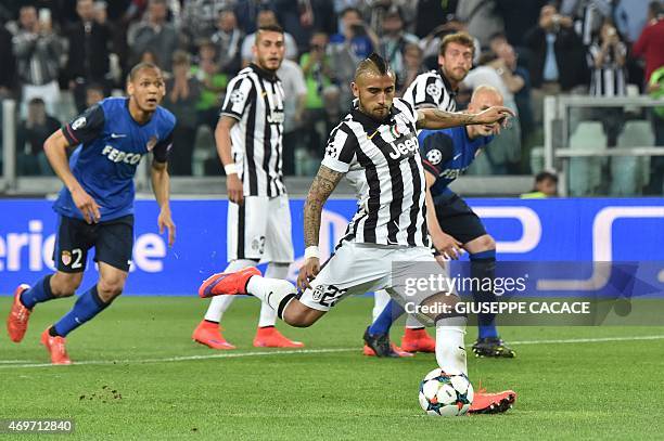 Juventus' midfielder from Chile Arturo Vidal kicks and score a penalty during the UEFA Champions League quarter final football match Juventus FC vs...