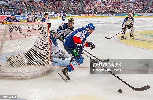 Andrew Joudrey of the Adler Mannheim handles the puck against Timo Pielmeier of ERC Ingolstadt during the game between Adler Mannheim and ERC...