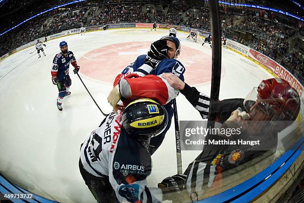 Jean-Francois Boucher of Ingolstadt gets in a scuffle with Kurtis Foster of Mannheim during the DEL Play-offs Final Game 3 between Adler Mannheim and...