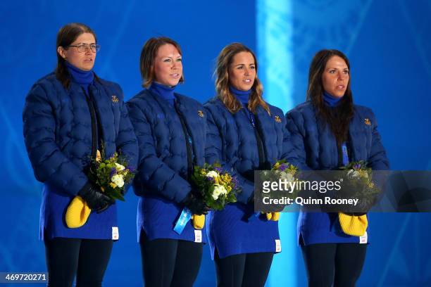 Gold medalists Sweden celebrate on the podium during the medal ceremony for the Women's 4 x 5 km Relay on day 9 of the Sochi 2014 Winter Olympics at...