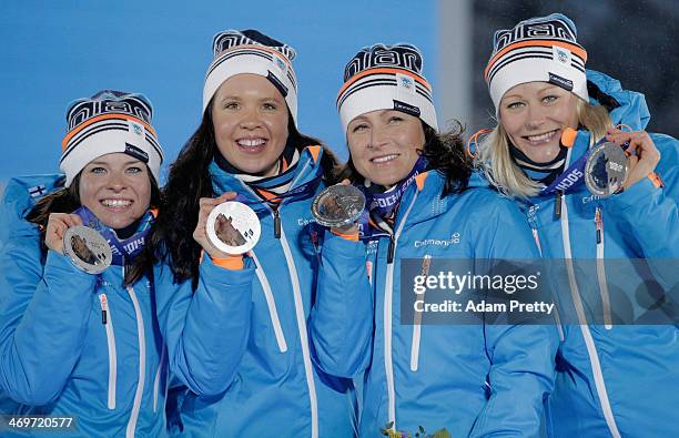 Silver medalists Finland celebrate on the podium during the medal ceremony for the Women's 4 x 5 km Relay on day 9 of the Sochi 2014 Winter Olympics...