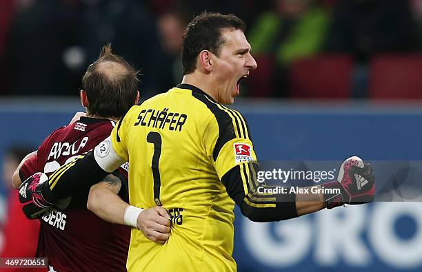 Goalkeeper Raphael Schaefer and Javier Pinola of Nuernberg celebrate after the Bundesliga match between FC Augsburg and 1. FC Nuernberg at SGL Arena...