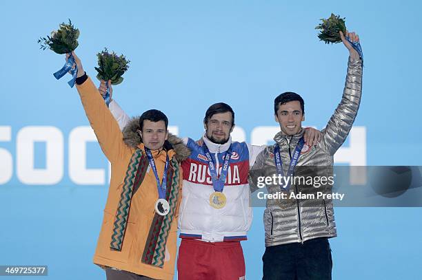 Silver medalist Martins Dukurs of Latvia, gold medalist Alexander Tretiakov of Russia and bronze medalist Matthew Antoine of United States celebrate...