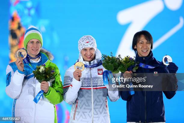 Bronze medalist Peter Prevc of Slovenia, gold medalist Kamil Stoch of Poland and silver medalist Noriaki Kasai of Japan celebrate on the podium...