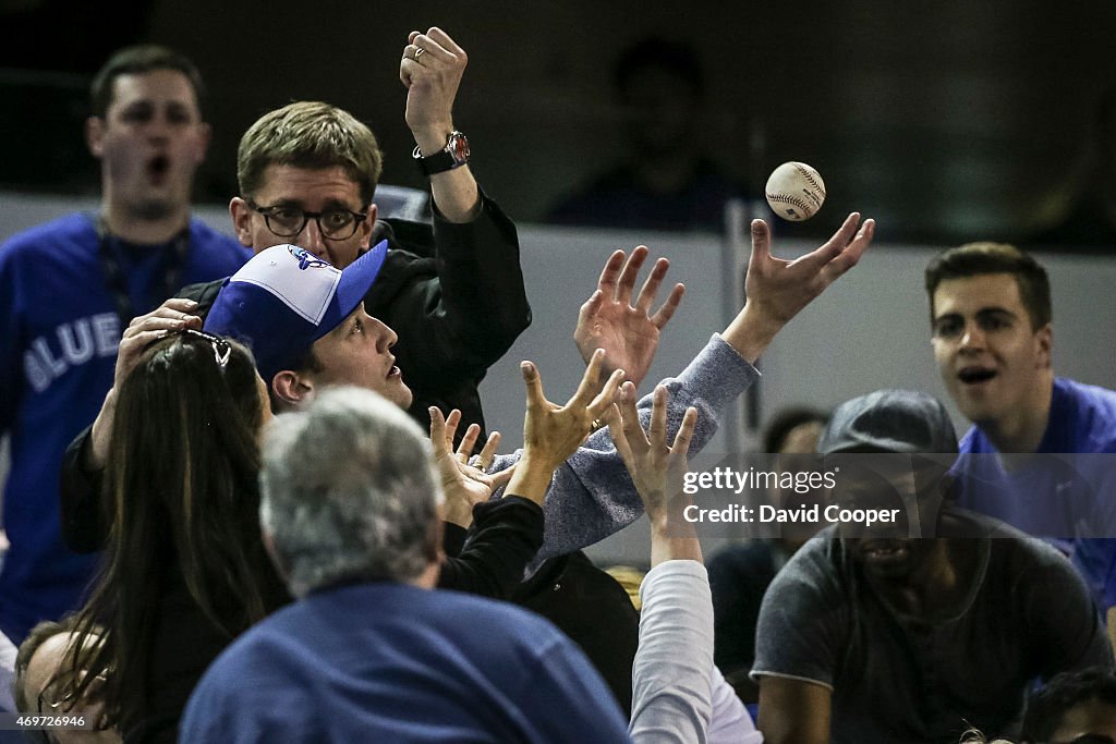 Toronto Blue Jays fans make a catch behind the plate