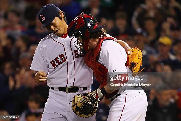 Koji Uehara of the Boston Red Sox and Ryan Hanigan celebrate after the ninth inning against the Washington Nationals at Fenway Park on April 14, 2015...
