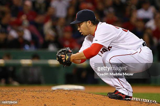 Junichi Tazawa of the Boston Red Sox stretches in between pitches against the Washington Nationals during the eighth inning at Fenway Park on April...