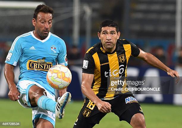 Perus Sergio Blanco of Sporting Cristal vies for the ball against Paraguays Luis Cabral of Guarani during the Copa Libertadores footballm match held...