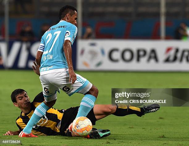 Paraguays Tomas Bartolomeus of Guarani slides against Perus Sporting Cristal Carlos Lobaton during the Copa Libertadores footballm match held at the...