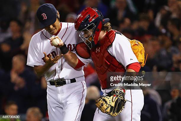 Koji Uehara of the Boston Red Sox and Ryan Hanigan celebrate after the ninth inning against the Washington Nationals at Fenway Park on April 14, 2015...