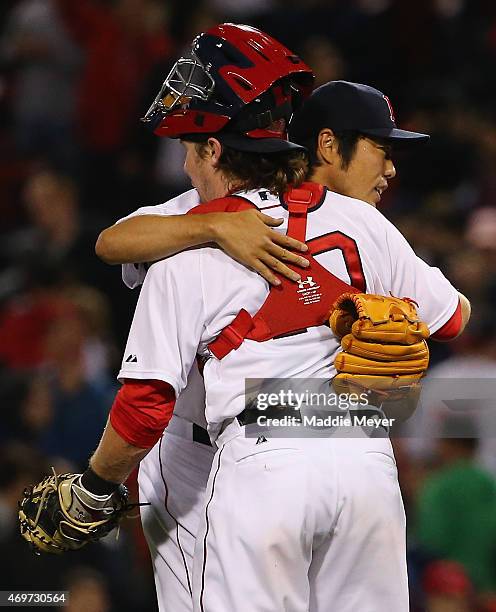 Koji Uehara of the Boston Red Sox and Ryan Hanigan celebrate after the ninth inning against the Washington Nationals at Fenway Park on April 14, 2015...