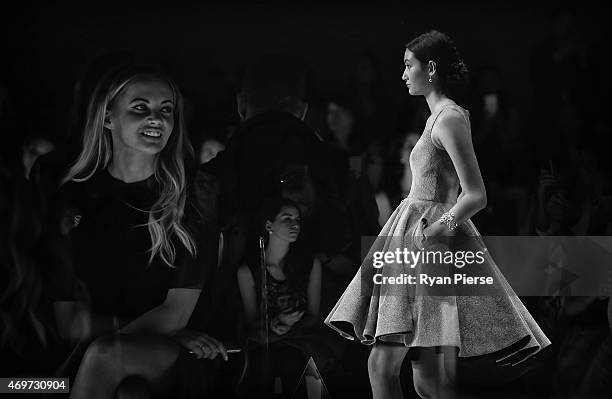 Singer Samantha Jade looks on as models showcase designs during the Steven Khalil Show at Mercedes-Benz Fashion Week Australia 2015 at Carriageworks...