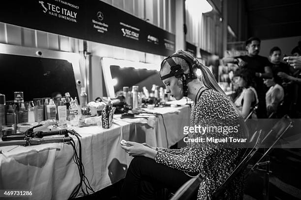 Model gets ready at the backstage during day one of Mercedes-Benz Fashion Week Mexico Fall/Winter 2015 at Campo Marte on April 14, 2015 in Mexico...