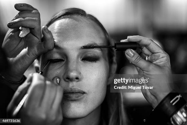 Model gets ready at the backstage during day one of Mercedes-Benz Fashion Week Mexico Fall/Winter 2015 at Campo Marte on April 14, 2015 in Mexico...