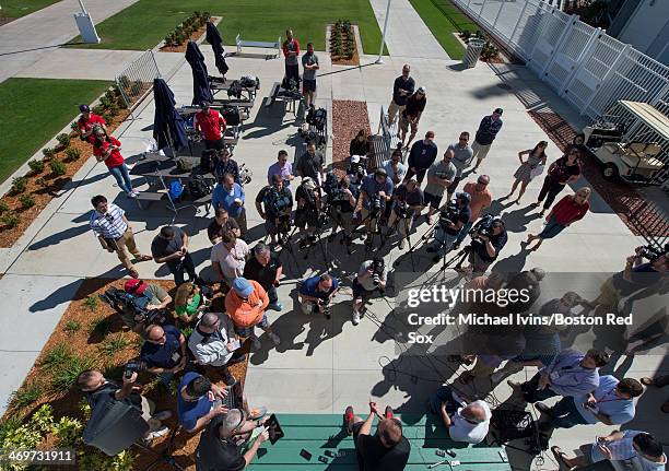 Members of the media and Red Sox personnel gather around pitcher Ryan Dempster during a press conference at Fenway South in which he announced he...