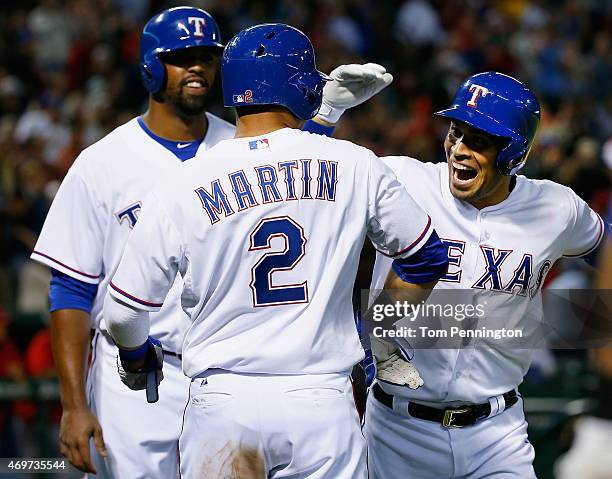 Robinson Chirinos of the Texas Rangers celebrates with Carlos Peguero of the Texas Rangers and Leonys Martin of the Texas Rangers after hitting a...