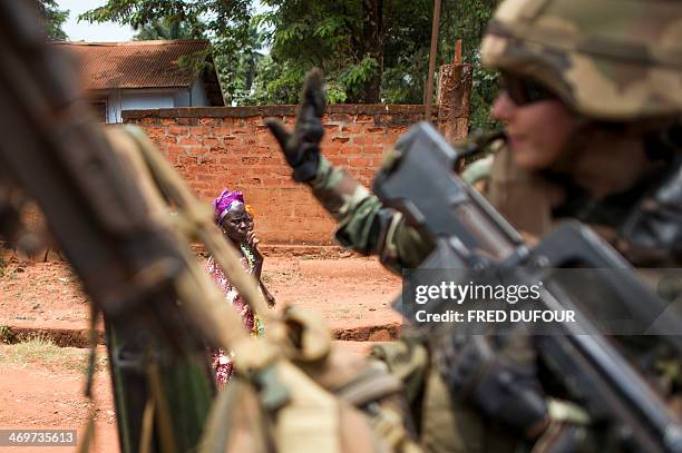 French soldier waves to people during a patrol, in Berberati, southwest of Central African Republic, on February 16, 2014. Troops from several EU...