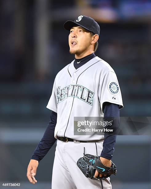 Hisashi Iwakuma of the Seattle Mariners reacts on the mound as he pitches against the Los Angeles Dodgers during the first inning at Dodger Stadium...