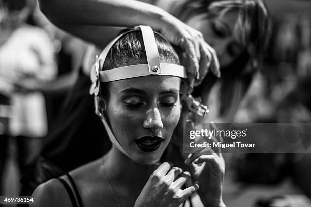 Model gets ready at the backstage during day one of Mercedes-Benz Fashion Week Mexico Fall/Winter 2015 at Campo Marte on April 14, 2015 in Mexico...