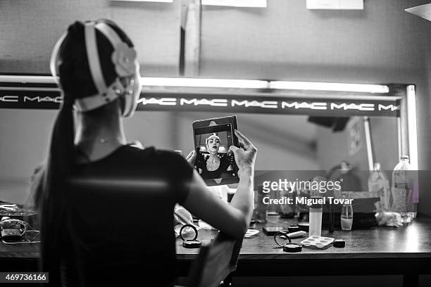 Model take a self-portrait with a tablet at the backstage during day one of Mercedes-Benz Fashion Week Mexico Fall/Winter 2015 at Campo Marte on...