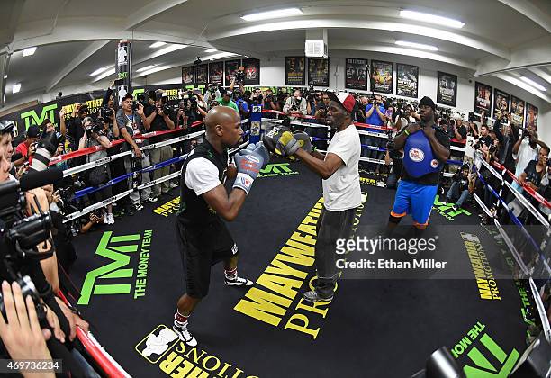 Welterweight champion Floyd Mayweather Jr. Works out with his uncle Roger Mayweather as co-trainer Nate Jones looks on at the Mayweather Boxing Club...