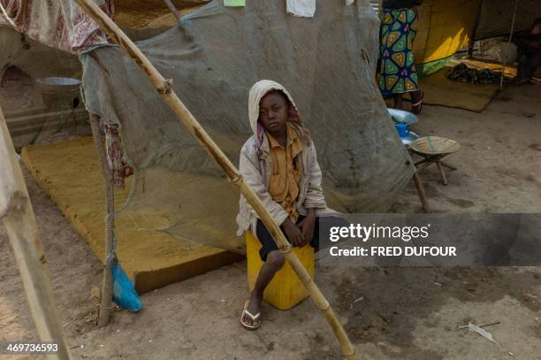 Boy sits while posing in Bangui, Central African Republic, on February 16, 2014. Troops from several EU countries will begin deploying in the...