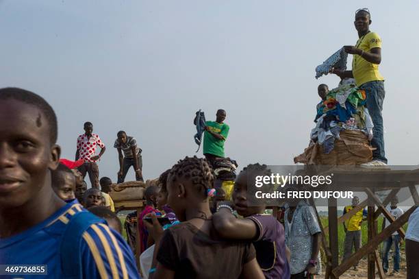 People gather to buy clothes at the Mpoko refugee camp in Bangui, Central African Republic, on February 16, 2014. Troops from several EU countries...