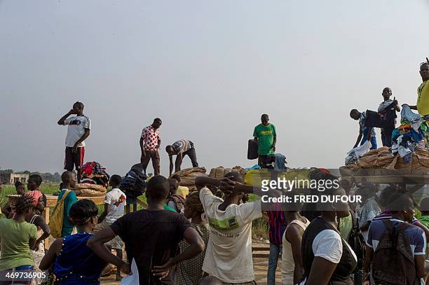 People gather to buy clothes at the Mpoko refugee camp in Bangui, Central African Republic, on February 16, 2014. Troops from several EU countries...