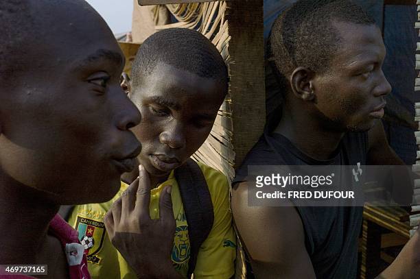 Men wait at the Mpoko refugee camp in Bangui, Central African Republic, on February 16, 2014. Troops from several EU countries will begin deploying...