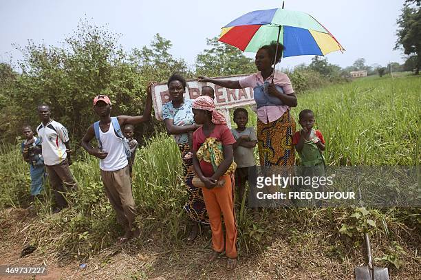 People gather at the entrance of Berberati, southwest of Central African Republic, on February 16, 2014. Troops from several EU countries will begin...