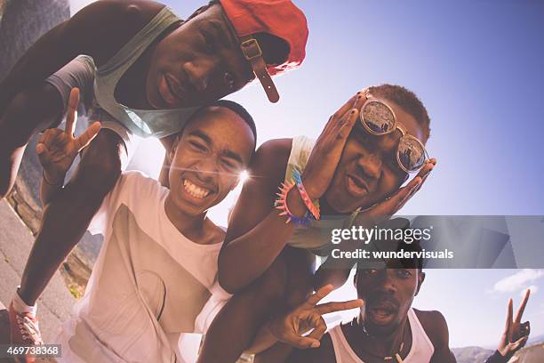 friendly teenagers of mixed races pulling funny faces - teen photography stock pictures, royalty-free photos & images