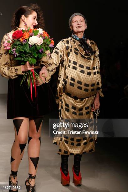 Designer Vivienne Westwood walks with a model on the runway after the Vivienne Westwood Red Label show at London Fashion Week AW14 at on February 16,...