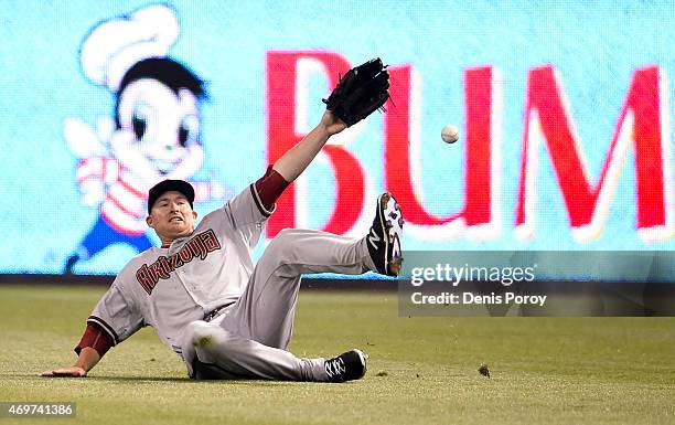 Mark Trumbo of the Arizona Diamondbacks can't make the catch on a triple hit by Matt Kemp of the San Diego Padres during the seventh inning of a...