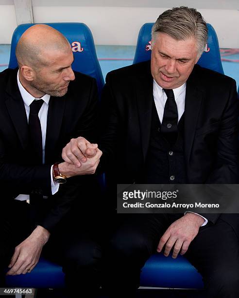 Head coach Carlo Ancelotti of Real Madrid CF shakes hands with his assistant coach Zinedine Zidane prior to the start of the La Liga match between...
