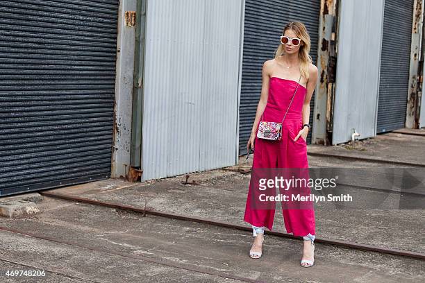 Model Natalie Cantell wears a Juliette Hogan jumpsuit, Furla bag, Sempre Di shoes and Karen Walker sunglasses at Mercedes-Benz Fashion Week Australia...