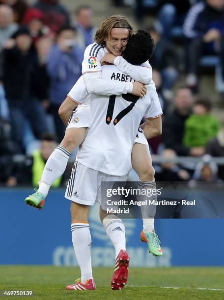 Luka Modric of Real Madrid celebrates with Alvaro Arbeloa after scoring their team's third goal during the La Liga match between Getafe and Real...