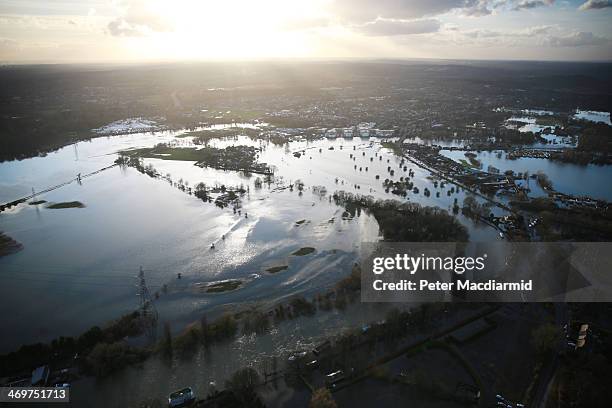 Flood water spills from the river Thames on February 16, 2014 in Chertsey, England. Housing near the river Thames has suffered a week of flooding...
