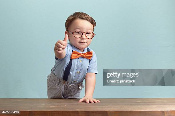 portrait of happy little boy giving you thumbs up - 3 fingers stockfoto's en -beelden