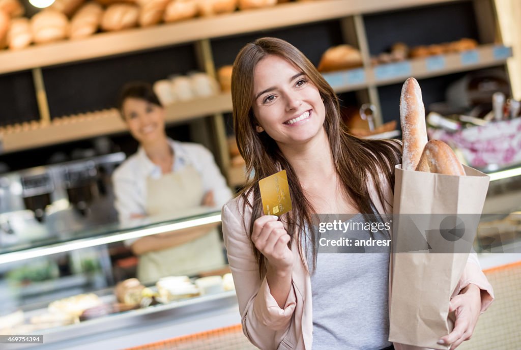 Woman paying by card at the bakery