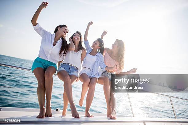 group of friends looking happy on a yacht - bachelorette stock pictures, royalty-free photos & images