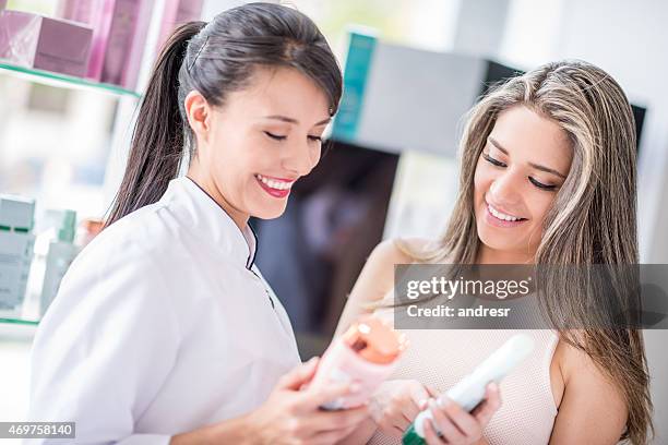 woman at the hairdresser buying hair care products - beautician client stock pictures, royalty-free photos & images