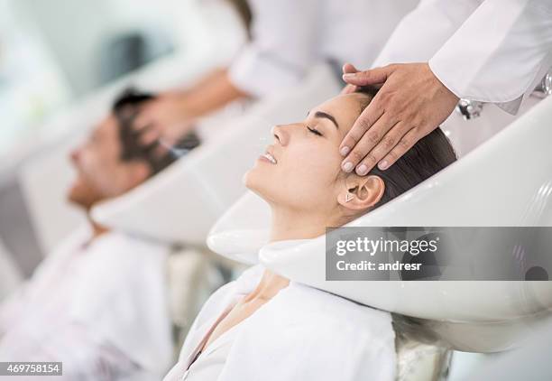 woman at the hairdresser washing her hair - hair mask stock pictures, royalty-free photos & images