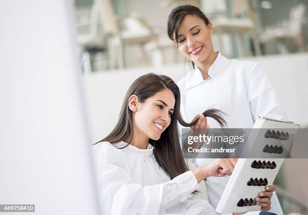 woman dyeing her hair at the hairdresser - färgmedel bildbanksfoton och bilder